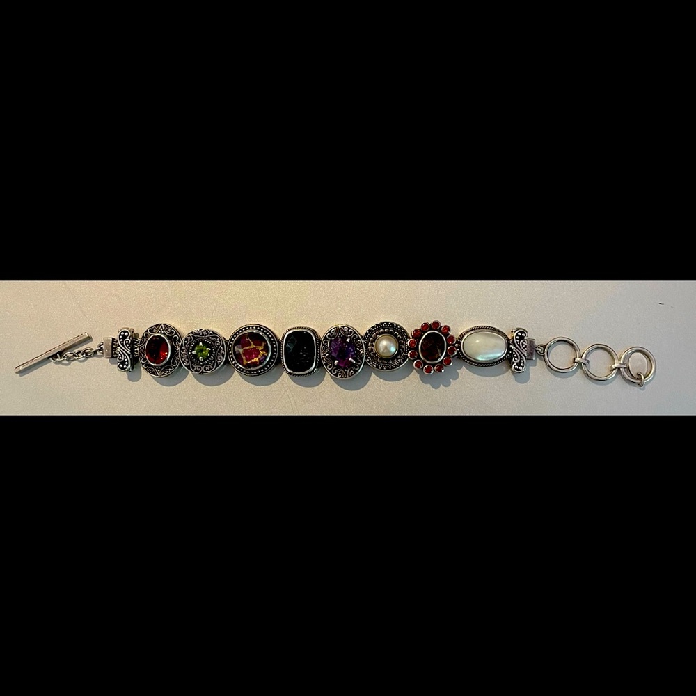 High quality sterling silver charm bracelet with genuine gemstones.